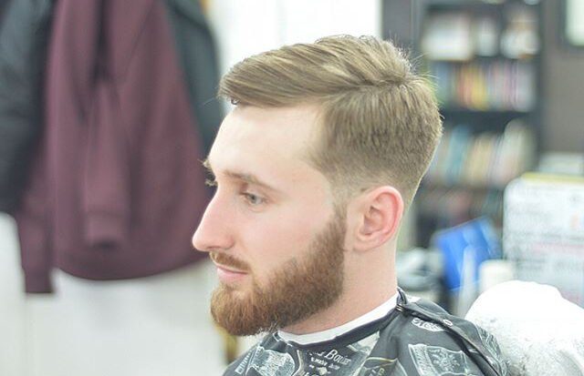 Slick back side part with shadow fade and beard